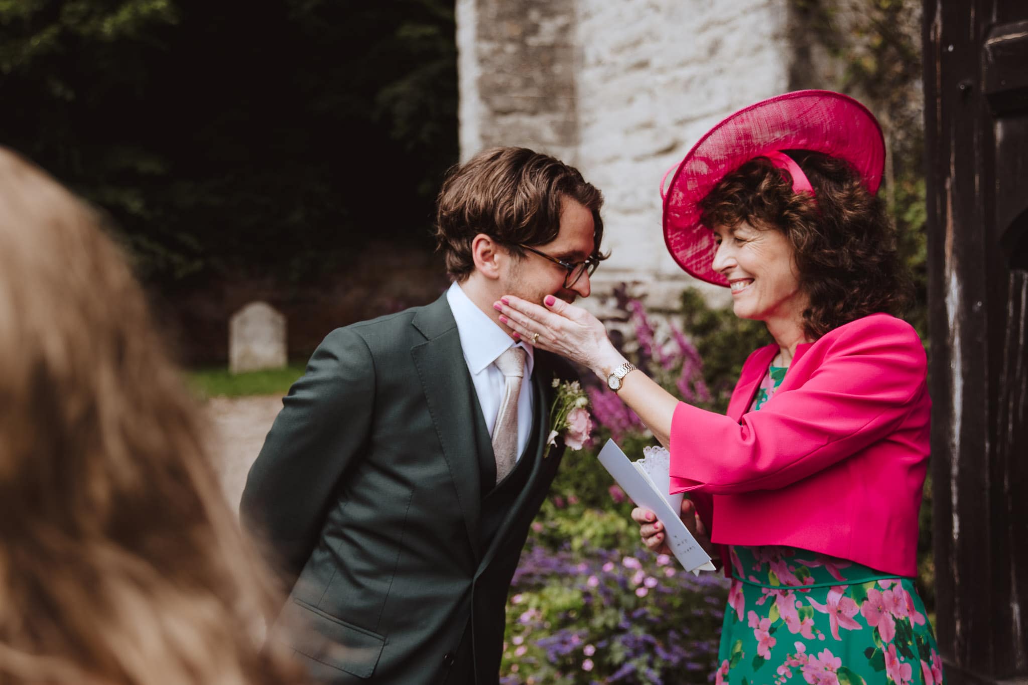 documentary photograph of wedding guest happy congratulating the groom