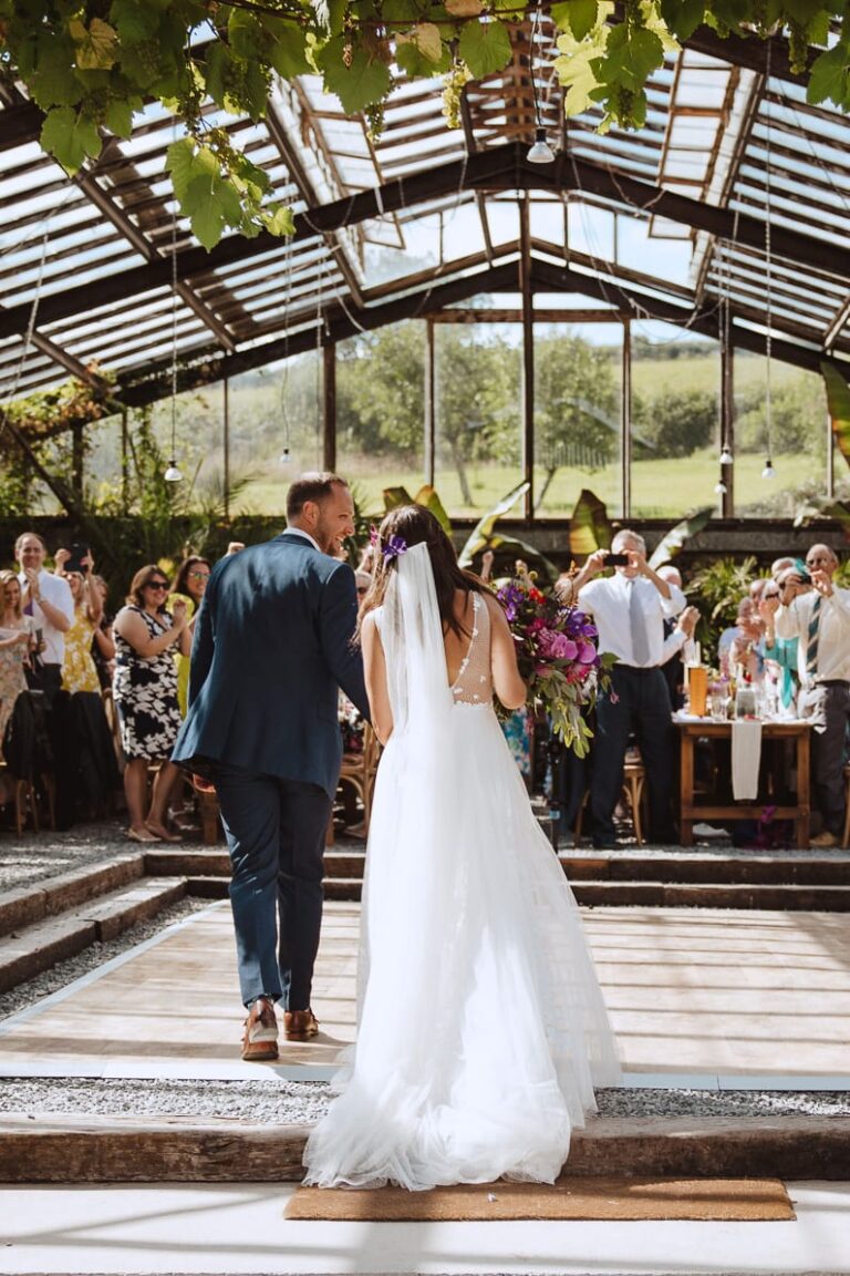 Bride and groom walking into their wedding