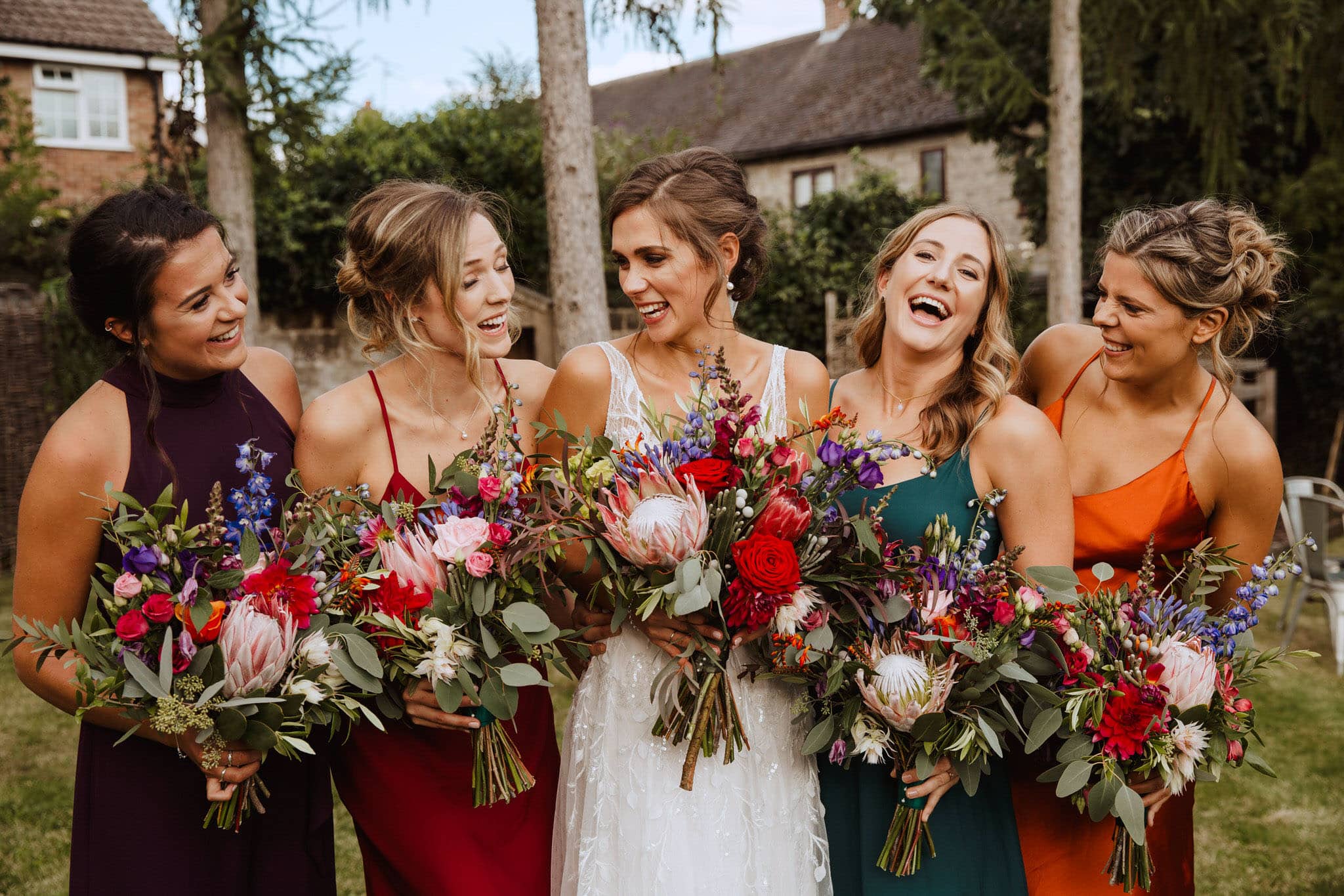 Bridesmaids laughing with bouquets - natural wedding photography Derby