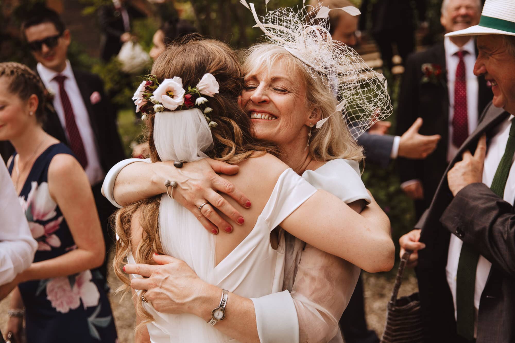 Bride hugging mother at outdoor wedding - documentary wedding photography Derbyshire