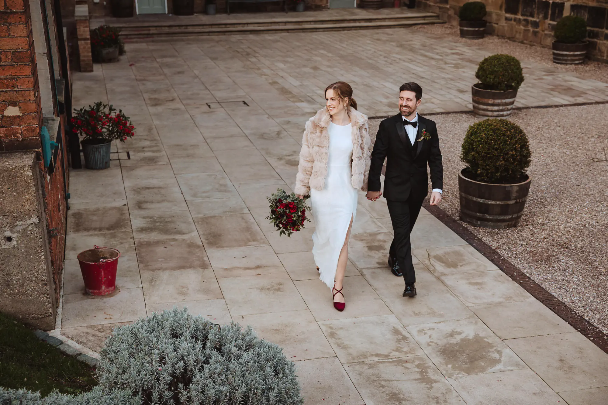 Bride in fur coat with groom the west mill - wedding videographer Derbyshire
